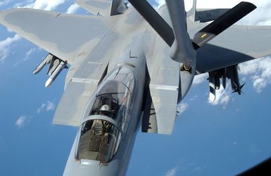 Over the South Pacific a US Air Force (USAF) F-15C Eagle fighter, 44th Fighter Squadron (FS), Kadena Air Base (AB), Okinawa refuels from a KC-135 Stratotanker, 909th Air Refueling Squadron (ARS), Kadena AB, Okinawa. The aircraft are participating in the Joint Exercise TANDEM THRUST 03, a joint exercise conducted in the Marianas islands to include Guam and Tinian. The exercise is a joint endeavor to include forces from the US, Canada, and Australia