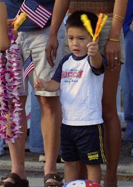 A little boy waits for the return of his father onboard the USN Arleigh Burke Class Guided Missile Destroyer, USS PAUL HAMILTON (DDG 60). The PAUL HAMILTON returned home to Pearl Harbor after a deployment spanning more than nine months for Operation IRAQI FREEDOM