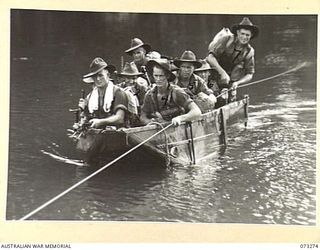 ALEXISHAFEN, NEW GUINEA. 1944-05-16. MEMBERS OF A SECTION FROM NO. 14 PLATOON, C COMPANY, 35TH INFANTRY BATTALION MAKE USE OF A CAPTURED JAPANESE COLLAPSIBLE PUNT TO CROSS THE REMPI RIVER DURING A ..