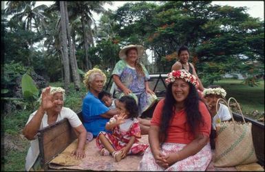 Group sitting on back of ute, Mangaia