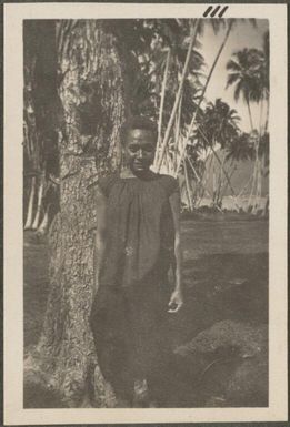 Papuan girl standing by a tree, New Britain Island, New Guinea, probably 1916