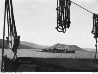 RABAUL, NEW BRITAIN. 1945-09-20. HMAS KANIMBLA AT ANCHOR IN SIMPSON HARBOUR. THE VULCAN CRATER IS IN THE BACKGROUND