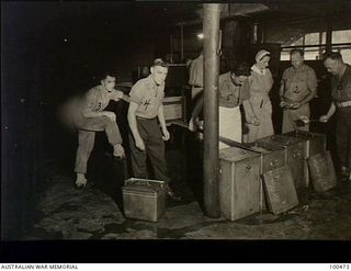 Port Moresby, New Guinea. 1944-05-29. Australian Army Sister C.A. Timbs, a dietitian, third from the right, with members of the kitchen staff of the 2/1st Australian General Hospital. The men, from ..