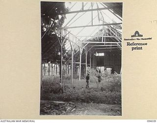 KULAURU MISSION, NEW GUINEA, 1945-07-11. MEMBERS OF A COMPANY, 2/5 INFANTRY BATTALION, MOVING INSIDE KULAURU MISSION PROBING FOR THE ENEMY