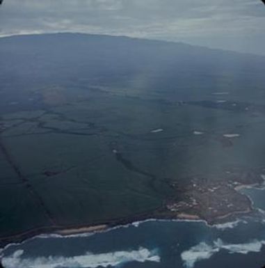 [Aerial view of mountain, agricultural, and coastal areas of Maui, United States]