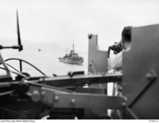 POTSDAM, NEW GUINEA. 1944-08-20. THE RAN CORVETTES, HMAS "ROCKHAMPTON" (LEADING) AND THE HMAS "COLAC" LADEN WITH TROOPS OF THE 25TH INFANTRY BATTALION APPROACHING THE RAN FRIGATE, HMAS "BARCOO" AT ..