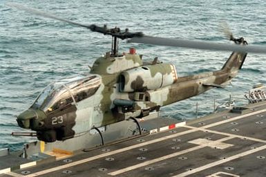 A Marine Heavy Helicopter Squadron 362 (HMH-362) AH-1W Sea Cobra helicopter lifts off from the amphibious assault ship USS SAIPAN (LHA-2) as the vessel is underway in support of maritime interdiction operations