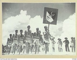 KELANOA, NEW GUINEA, 1944-02-20. THE 5TH DIVISION ARMY SERVICE CORPS TEAM IN THE MARCHPAST AT THE MOST FORWARD BEACH CARNIVAL HELD IN NEW GUINEA. THE CARNIVAL WAS ORGANISED BY CAPTAIN A.E. RICHARDS ..