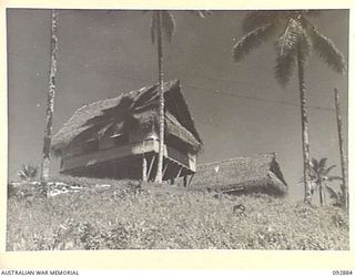 JACQUINOT BAY, NEW BRITAIN. 1945-06-09. THE TYPE OF BUILDING USED AS OFFICE AND LIVING QUARTERS BY SENIOR OFFICERS OF HEADQUARTERS 5 BASE SUB-AREA. NATIVES BUILT THE HUTS FROM BUSH TIMBER AND ..