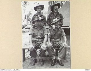 CAPE PUS, NEW GUINEA. 1945-11-03. CHAPLAIN N.D. WINN, 2/2 INFANTRY BATTALION (1) PHOTOGRAPHED WITH SERGEANT S.E. BAILEY (2), LANCE CORPORAL W.T. FALLSHAW (3) AND CORPORAL C. LETCHFIELD (4) WHO WERE ..