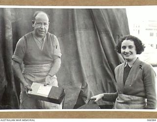 MEMBERS OF THE 3RD BASE ORDNANCE DEPOT AT WILSON STREET, TROPIC PROOFING PACKAGES OF SPARE PARTS BY DIPPING THEM IN HOT WAX BEFORE DESPATCHING THEM TO NEW GUINEA. NOTE THE LABELS DENOTING CONTENTS ..