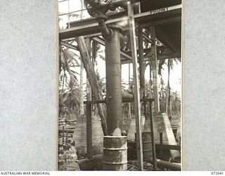MILNE BAY, NEW GUINEA. 1944-04-04. THE WATER INTERCEPTOR FITTED TO 12,000 GALLON STORAGE TANKS AT THE 2ND AUSTRALIAN BULK PETROLEUM STORAGE COMPANY