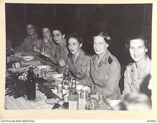 TOROKINA, BOUGAINVILLE. 1945-07-02. THE MAIN TABLE IN THE SISTERS' MESS, 2/1 GENERAL HOSPITAL, DURING A FORMAL DINNER CELEBRATING THE 43RD ANNIVERSARY OF THE AUSTRALIAN ARMY NURSING SERVICE. ..