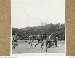 ELA BEACH, NEW GUINEA. 1944-01-01. FINISH OF THE 100 YARDS SPRINT AT THE ALLIED SERVICES GRAND SPORTS CARNIVAL. THE RESULT WAS: FIRST - NX150795 PRIVATE J. WOODS, 33RD AUSTRALIAN EMPLOYMENT COMPANY ..