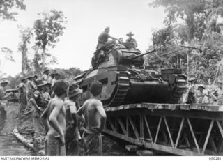 BOUGAINVILLE. 1945-03-30. 15 FIELD COMPANY, ROYAL AUSTRALIAN ENGINEERS (RAE), SAPPERS WATCHING B SQUADRON, 2/4 ARMOURED REGIMENT MATILDA TANKS CROSSING A 24 TON BOX GIRDER BRIDGE AT COOMBES ..