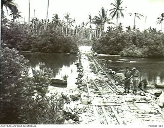 NEW IRELAND, 1945-10. ALLIED ARMY AND AIR FORCE OFFICERS INSPECTING A JAPANESE DESIGNED LOW LEVEL RIVER CROSSING. (RNZAF OFFICIAL PHOTOGRAPH.)