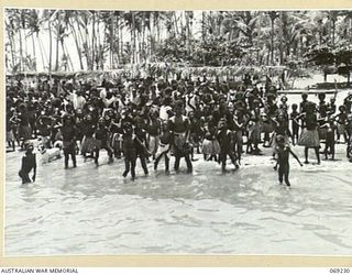 NEW GUINEA. 1942. NATIVES GREETING PPI. MAJOR GENERAL B.M. MORRIS, DSO, COMMANDING OFFICER, NEW GUINEA LINES OF COMMUNICATION AREA AND THE AUSTRALIAN AND NEW GUINEA ADMINISTRATIVE UNIT ON HIS ..