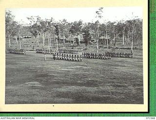 BISIATABU, NEW GUINEA. 1944-04-19. TROOPS OF THE PAPUAN INFANTRY BATTALION FORMED ON THE UNIT PARADE GROUND DURING THE VISIT TO THE AREA BY THE HONOURABLE E.J. WARD, MINISTER FOR EXTERNAL ..