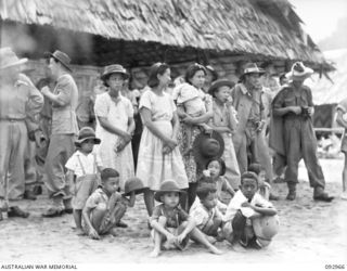 TOROKINA, BOUGAINVILLE. 1945-06-10. NATIVE SING-SING AT THE WEBB ROAD COMPOUND ON THE NUMA NUMA TRAIL WHICH WAS ATTENDED BY A LARGE NUMBER OF TROOPS. THE NATIVES PARTICIPATING ARE ATTACHED TO ..