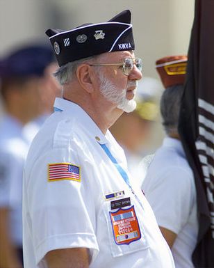 A Korean War Veteran, Ed "Doc" Brown stands at attention during a repatriation ceremony held July 10, 2001 at Hickam AFB, Hawaii. Dozens of Veterans were in attendance to honor the 17 unaccounted for US serviceman from North Korea, Vietnam and Laos