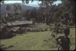 Group of people gathered outside village buildings