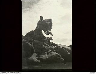PAPUA-NEW GUINEA. C. 1942-12. LEADING AIRCRAFTMAN KIRKPATRICK UNLOADING ANOTHER MAILBAG OFF THE TRUCK. RAAF CHRISTMAS MAIL HAS ARRIVED AT MOST FORWARD BASES IN THE NEW GUINEA AREA AND RAAF POST ..