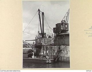 OCEAN ISLAND. 1945-10-01. A GROUP OF JAPANESE UNLOADING SUPPLIES FOR THE OCCUPATION FORCE FROM THE SS RIVER BURDEKIN. FOLLOWING THE SURRENDER OF THE JAPANESE TROOPS OF 31/51 INFANTRY BATTALION ..
