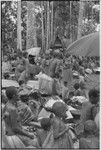 Mortuary ceremony, Omarakana: crowd of mourning women conduct ritual exchange of banana leaf bundles