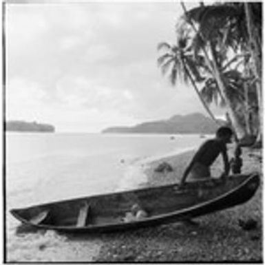 Man pulling canoe ashore