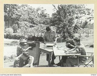 LAE, NEW GUINEA. 1944-11-11. PATIENTS OF THE 112TH CONVALESCENT DEPOT ENGAGED IN HOBBY THERAPY IN THE TROPICAL SUNSHINE. IDENTIFIED PERSONNEL ARE: VX115916 PRIVATE R. MARCHANT, 7TH INFANTRY ..