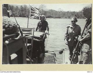 BOUGAINVILLE. 1945-03-31. LADY WAKEHURST (2), WALKING ALONG THE DECK OF A 42 LANDING CRAFT COMPANY VESSEL BEFORE LANDING AT FREDDIE BEACH, SORAKEN, DURING HER VISIT WITH LORD WAKEHURST AND LADY ..