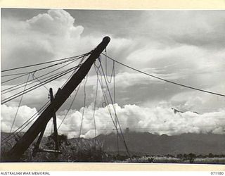 EVAPIA RIVER, NEW GUINEA, 1944-03-15. THE HUGE MAIN SUPPORT FOR THE SUSPENSION BRIDGE UNDER CONSTRUCTION OVER THE EVAPIA RIVER NEAR KESAWAI, BEING HOISTED INTO POSITION BY ENGINEERS FROM THE 2/4TH ..