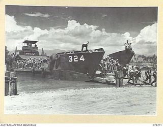 TOROKINA, BOUGAINVILLE ISLAND. 1945-01-02. TROOPS OF THE 24TH INFANTRY BATTALION, DISEMBARKING FROM AN LANDING CRAFT TROOPS DURING THE UNIT MOVE TO THE JABA RIVER AREA