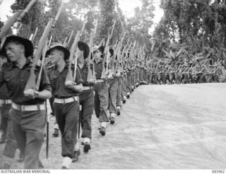 TOROKINA, BOUGAINVILLE, SOLOMON ISLANDS. 1944-12-15. "A" COMPANY, 47 INFANTRY BATTALION TROOPS PASS THE SALUTING DAIS DURING THE MARCH PAST. THE SALUTE WAS RETURNED BY MAJOR GENERAL W. BRIDGEFORD, ..