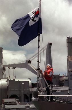 A Korean Navy sailor raises the his nation's flag aboard the ROKS CHUNG NAM (FF 953) during exercise RIMPAC '98