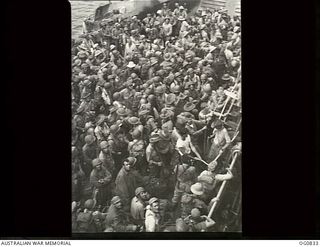 MOMOTE, LOS NEGROS ISLAND, ADMIRALTY ISLANDS. 1944-03-18. RAAF REINFORCEMENTS, TOGETHER WITH AMERICAN TROOPS, WAITING TO GO ASHORE ON LOS NEGROS ISLAND FROM A LANDING CRAFT TANK