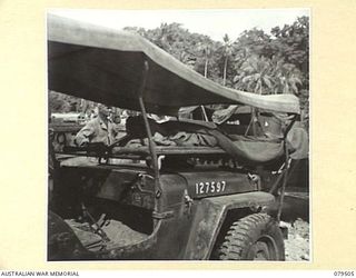 LAUNCH JETTY, NEW GUINEA: 1944-01. A PATIENT IN AN AMBULANCE JEEP AT THE ADVANCED DRESSING STATION, LAUNCH JETTY, 10TH FIELD AMBULANCE