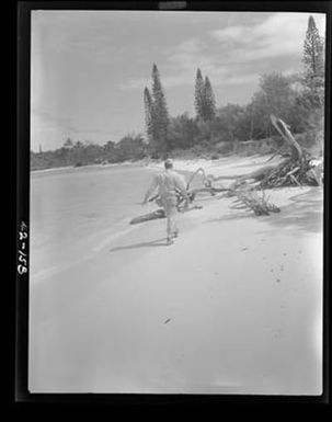 [Negative of Soldier Walks on Beach]