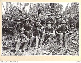 LIEUTENANT J.M. TRETHOWAN, 2/8 INFANTRY BATTALION (7), WITH MEMBERS OF HIS SECTION WHO ASSISTED IN THE CAPTURE OF THE STRONGLY DEFENDED POSITIONS ON MOUNT SHIBURANGU. IDENTIFIED PERSONNEL ARE:- ..