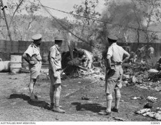 PAPUA, NEW GUINEA. 1942-07-27. "LOOKS LIKE I'VE MISSED MY SEAT", SAID GENERAL SCANLON, COMMANDING AMERICAN AIR FORCE IN NEW GUINEA, ON RIGHT, AS HE INSPECTS THE PLANE IN WHICH HE WAS TO HAVE MADE A ..