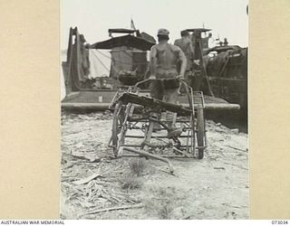 MADANG, NEW GUINEA. 1944-04-28. THIS JAPANESE HANDCART WAS DISCOVERED ON THE BEACH AT MATUPI PLANTATION LOADED WITH A SALVAGED LIGHT MACHINE GUN AND OPTICAL INSTRUMENTS. MOST OF THE EQUIPMENT WAS ..