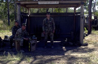 Marines from India Company, 3rd Battalion, 3rd Marines weapon platoon, Kaneohe Bay, Hawaii stand guard over their weapons during Exercise TANDEM THRUST. India Company is conducting a live fire range exercise consisting of firing AT-4 Rocket Launchers, Shoulder Mounted Anti Armor Weapons, and M-2O3 Grenade Launchers at the Shoalwater Bay Training Area. TANDEM THRUST is a biennial combined United States and Australian military training exercise, held in the vicinity of Shoalwater Bay Training Area in Queensland, Australia. More than 27,000 Soldiers, Sailors, Airmen and Marines are participating, with Canadian units taking part as opposing forces. The purpose of Exercise TANDEM THRUST is to...