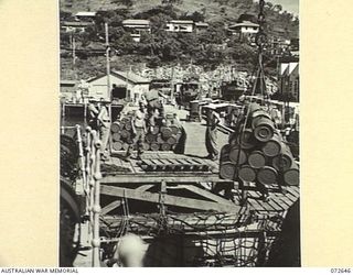 PORT MORESBY, NEW GUINEA. 1944-04-26. THE UNLOADING OF SUPPLIES FROM HMT MONTORO DIRECTLY TO TRUCKS ALONGSIDE PORT MORESBY WHARF FOR TRANSPORTATION TO NO.5 BASE SUPPLY DEPOT. THE DOCKS ARE OPERATED ..