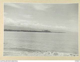 LABU, NEW GUINEA. 1944-10-03. A LONG SHOT OF THE TOWN OF LAE TAKEN FROM LABU