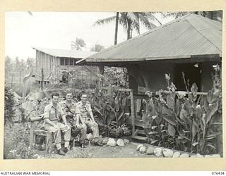 LAE, NEW GUINEA. 1944-10-04. SX32659 LIEUTENANT C.H. MORRIS (1), SX32660 SERGEANT H.W. WEST (2) AND SX32376 WARRANT OFFICER II, K.F. MELBANK (3) OUTSIDE THEIR QUARTERS AT THE AUSTRALIAN ARMY ..