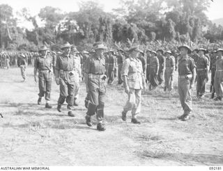 TOROKINA, BOUGAINVILLE. 1945-05-18. LIEUTENANT GENERAL S.G. SAVIGE, GENERAL OFFICER COMMANDING 2 CORPS (5), ACCOMPANIED BY CAPTAIN M.E. JUST (4), AND SENIOR OFFICERS DURING AN INSPECTION OF MEN OF ..