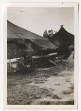 Army tent with bench and chair outside. Fiji