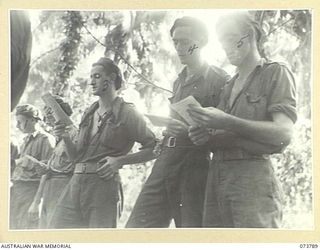 KARKAR ISLAND, NEW GUINEA. 1944-06-02. MEMBERS OF THE 37/52ND INFANTRY BATTALION SINGING HYMNS DURING AN OPEN AIR CHURCH OF ENGLAND SERVICE AT BISON BAY. IDENTIFIED PERSONNEL ARE:- VX136005 PRIVATE ..