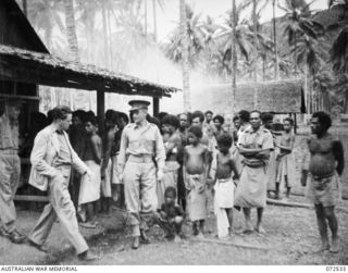 MILNE BAY, NEW GUINEA. 1944-04-20. THE HONOURABLE E.J. WARD, MINISTER FOR EXTERNAL TERRITORIES IN THE AUSTRALIAN GOVERNMENT (2), WITH WARRANT OFFICER II, K.M. CHAMBERS, ASSISTANT DIRECTOR OF NATIVE ..