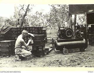 PORT MORESBY, NEW GUINEA. 1944-02-02. VX112500 SERGEANT H.V. HOLLOWAY, STENCILLING DETAILS ON AMMUNITION BOXES AFTER COMPLETION OF REPAIRS BY THE 6TH MOBILE AMMUNITION REPAIR SHOP AT THE 8TH ..